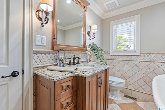 bathroom with crown molding, tile flooring, toilet, vanity, and tile walls