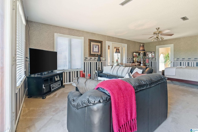 living room with ceiling fan and light colored carpet