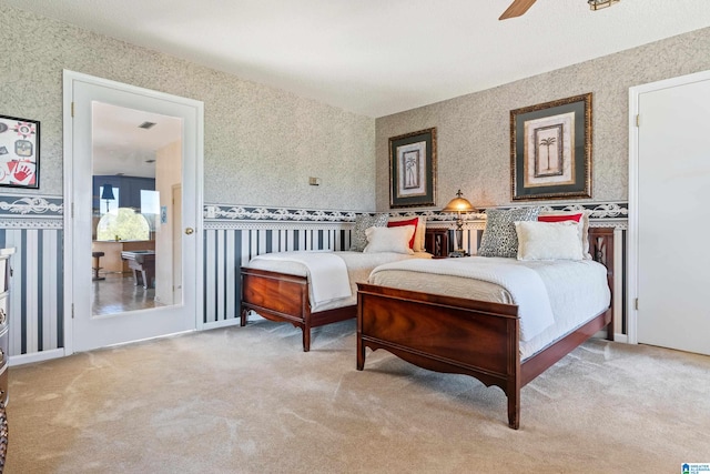 bedroom with ceiling fan and light colored carpet