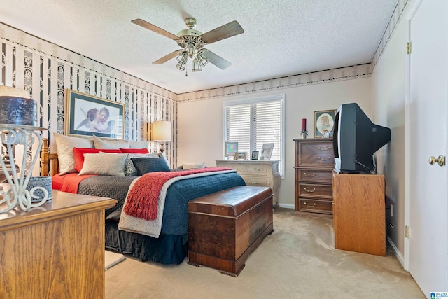 carpeted bedroom featuring a textured ceiling and ceiling fan