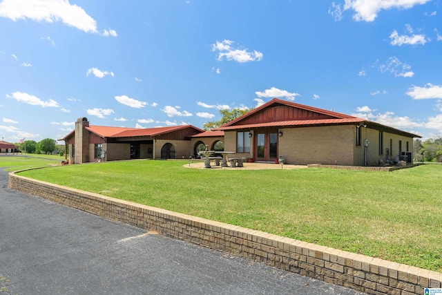 exterior space featuring a patio area and a lawn
