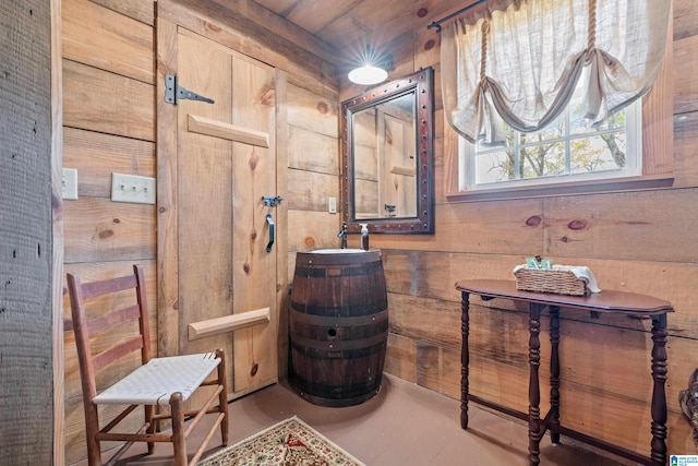 bathroom with wooden ceiling and wood walls