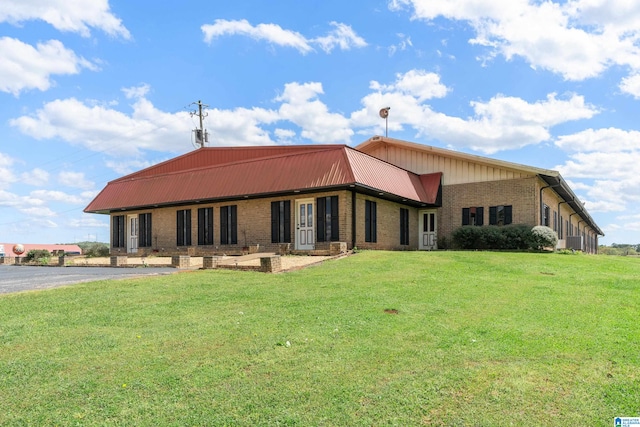 rear view of house featuring a yard