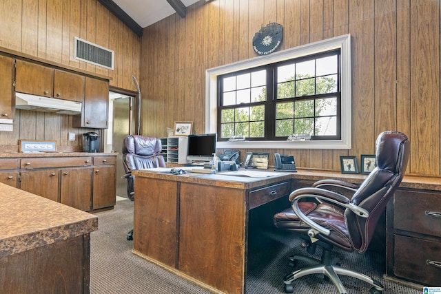 carpeted office featuring wooden walls and lofted ceiling