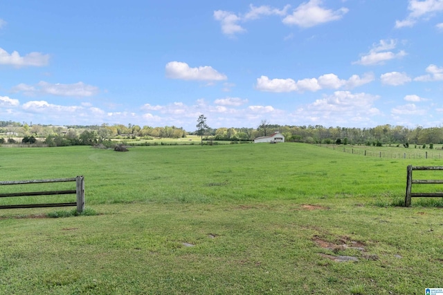 view of gate featuring a rural view and a yard