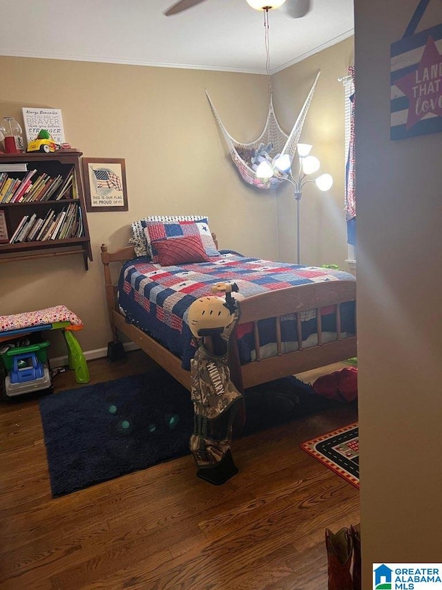 bedroom with dark hardwood / wood-style floors, ornamental molding, and ceiling fan with notable chandelier