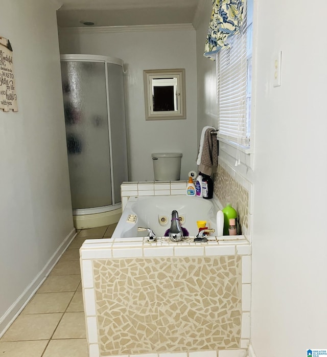 bathroom with ornamental molding, toilet, plus walk in shower, and tile floors