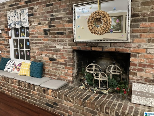 interior details featuring crown molding, hardwood / wood-style flooring, and a fireplace