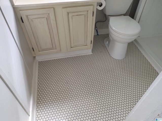 bathroom featuring toilet and tile floors