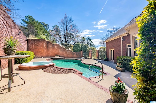 view of pool featuring an in ground hot tub and a patio