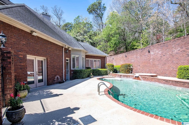 view of pool featuring a patio and french doors