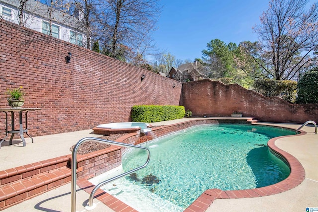 view of pool featuring a patio area, pool water feature, and a jacuzzi