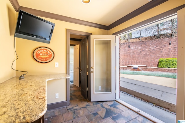 doorway to outside with crown molding