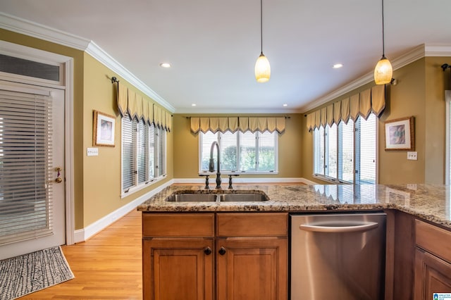 kitchen with crown molding, stainless steel dishwasher, sink, and pendant lighting