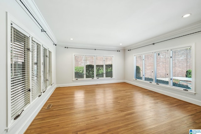 interior space with light hardwood / wood-style flooring and ornamental molding