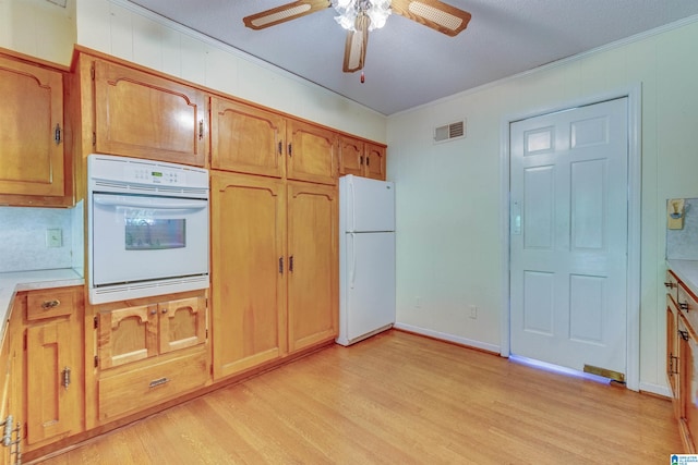 kitchen featuring light hardwood / wood-style flooring, ceiling fan, and white appliances