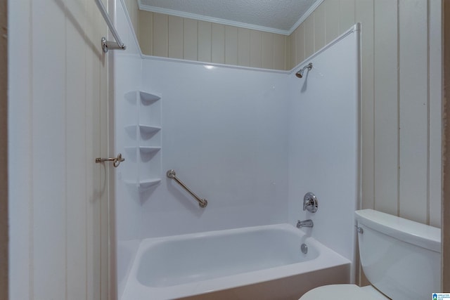 bathroom featuring a textured ceiling, tub / shower combination, toilet, and crown molding