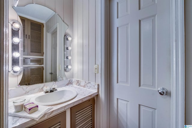 bathroom featuring ornamental molding and vanity