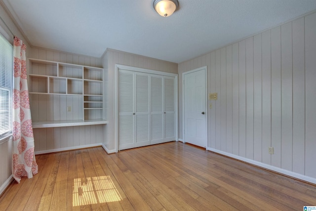 unfurnished bedroom featuring hardwood / wood-style flooring and a closet