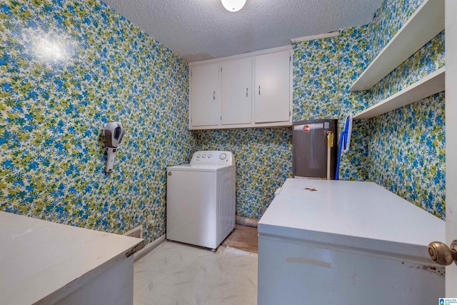 laundry room featuring a textured ceiling, cabinets, washer / clothes dryer, and light tile flooring