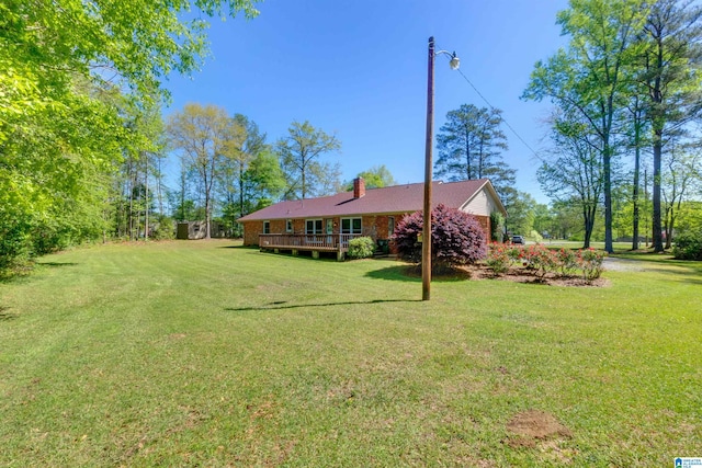 view of yard with a wooden deck