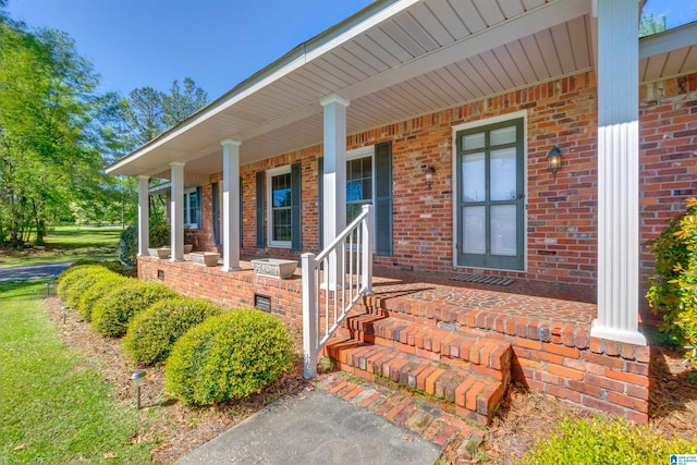 view of exterior entry featuring a porch