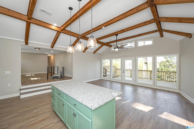 kitchen with dark wood-type flooring, ceiling fan, decorative light fixtures, and a kitchen island