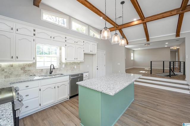 kitchen featuring dishwasher, decorative light fixtures, white cabinets, and a kitchen island