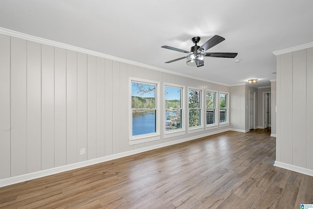 unfurnished living room with hardwood / wood-style flooring, ceiling fan, and ornamental molding