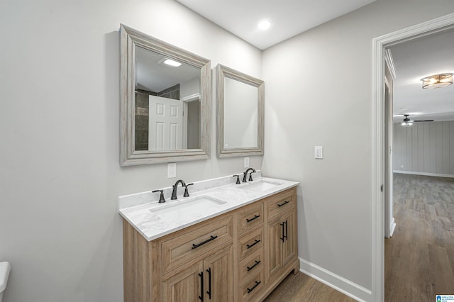 bathroom with ceiling fan, wood-type flooring, and vanity