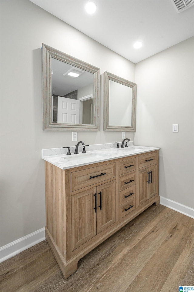 bathroom with vanity and hardwood / wood-style flooring