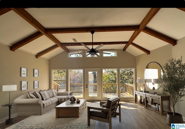 living room with hardwood / wood-style flooring, ceiling fan, and high vaulted ceiling