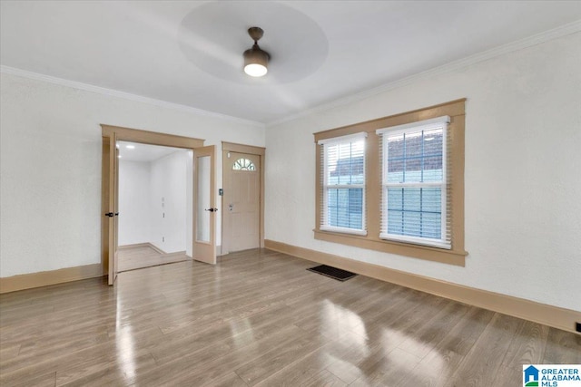 entryway featuring ornamental molding, hardwood / wood-style floors, and ceiling fan