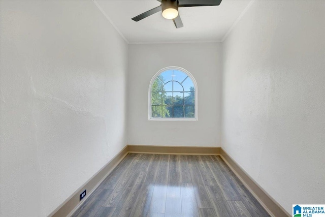 unfurnished room with ceiling fan, ornamental molding, and dark wood-type flooring