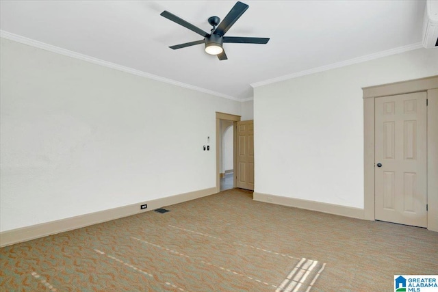 empty room with ceiling fan, ornamental molding, and light carpet