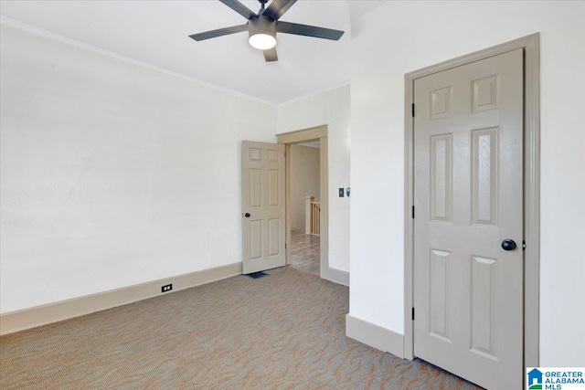 unfurnished room featuring ceiling fan, ornamental molding, and light carpet