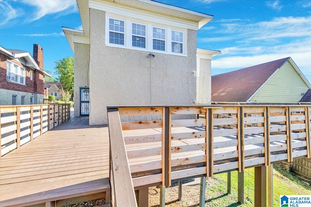 rear view of property featuring a wooden deck