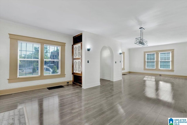 spare room with wood-type flooring and a notable chandelier