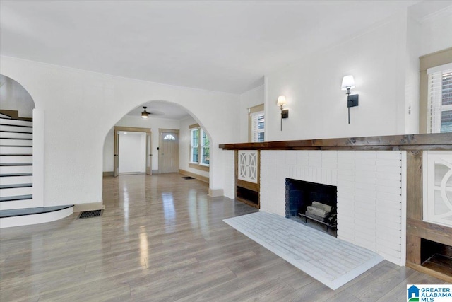 living room featuring light wood-type flooring and a fireplace