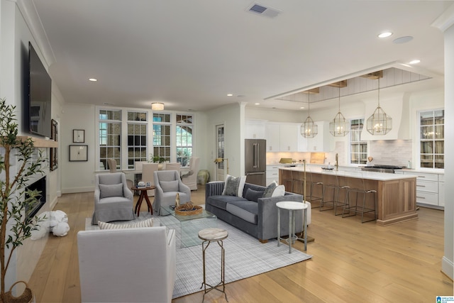 living room featuring a chandelier and light hardwood / wood-style floors