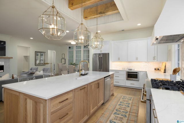 kitchen with premium range hood, white cabinetry, decorative light fixtures, and appliances with stainless steel finishes