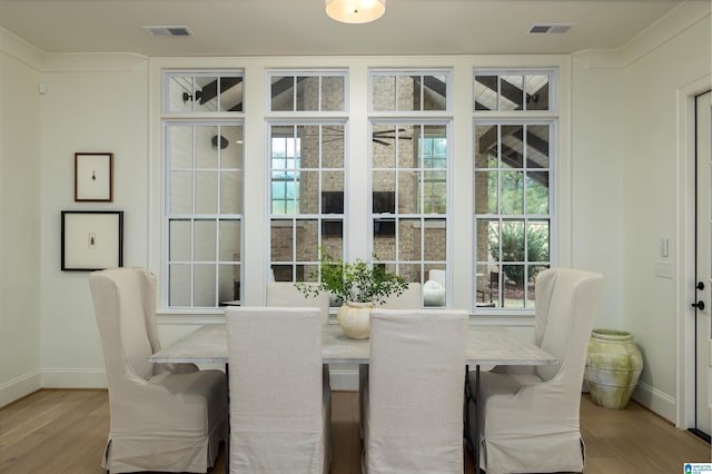 dining space with light hardwood / wood-style floors