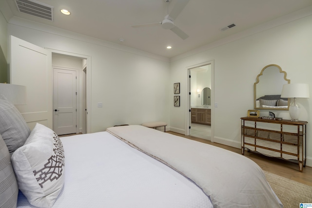 bedroom featuring connected bathroom, ceiling fan, wood-type flooring, and ornamental molding