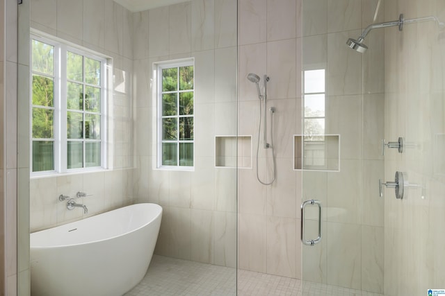 bathroom with tile patterned floors, tile walls, and independent shower and bath