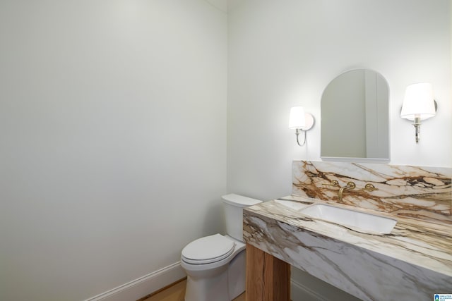 bathroom featuring toilet and sink