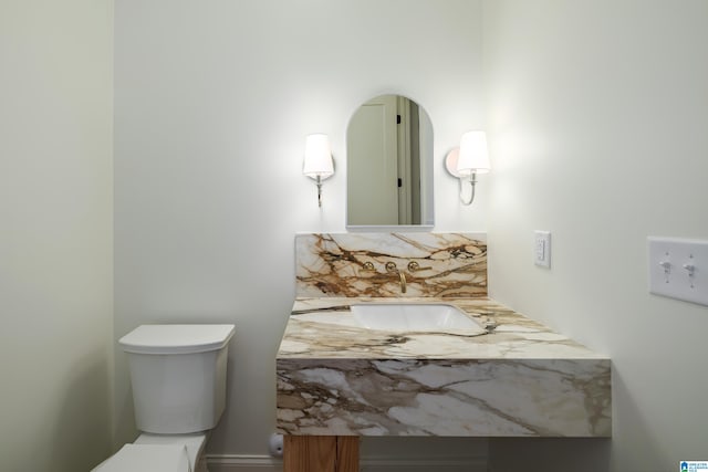 bathroom featuring vanity and toilet