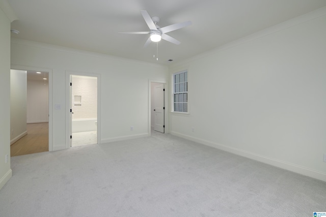 carpeted empty room with ceiling fan and crown molding