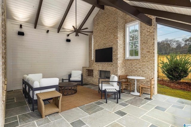 view of patio / terrace featuring an outdoor living space with a fireplace and ceiling fan