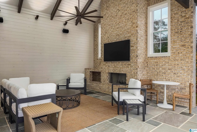 view of patio / terrace with ceiling fan and an outdoor stone fireplace