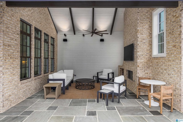 view of patio featuring ceiling fan and a fireplace